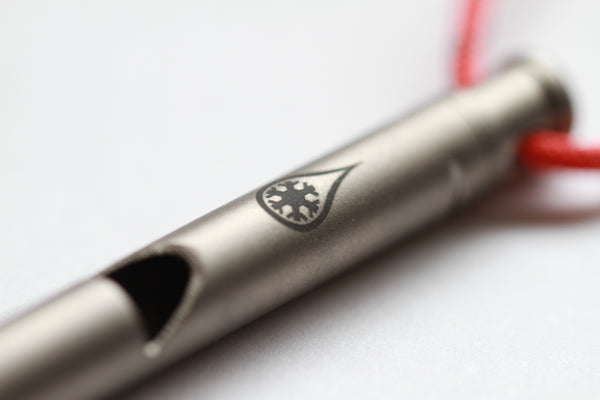Survival Whistle by Kind Design - close-up of logo and whistle mouthpiece
